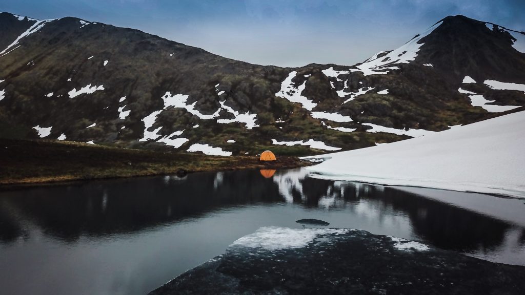 Tent camping near a lake on the Summit Creek Trail